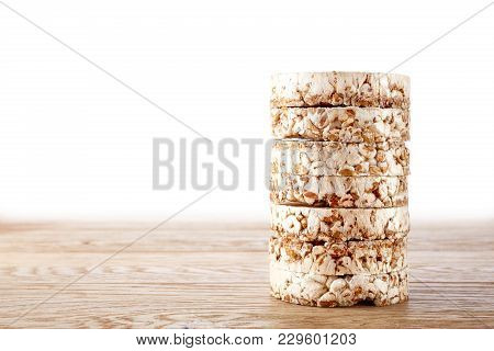 Stack Of Buckwheat Crispbreads On Light Wooden Table