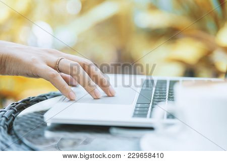 Asian Woman Hands And Married Ring Has Touching And Typing On Laptop Computer With Blurred Coffee, C