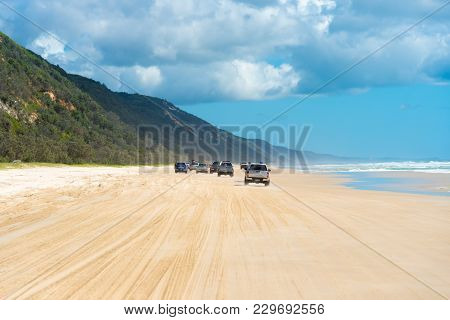 4Wd Vehicles At Rainbow Beach With Coloured Sand Dunes, Qld, Australia