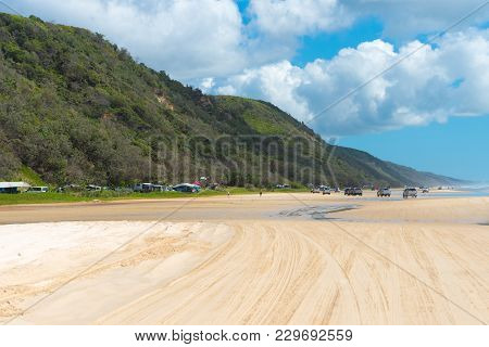 4Wd Vehicles At Rainbow Beach With Coloured Sand Dunes, Qld, Australia