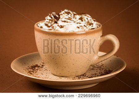Cooffee Drink Or Cappuccino Cup With Whipped Cream On Brown Background.