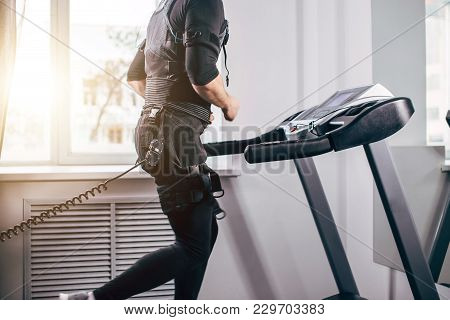 Fit Man In Black Suit For Ems Training Preparing For Running On Treadmill At Gym