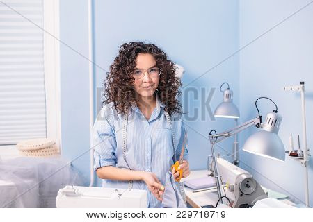 Nice Tailor With Wavy Hair Looking At Camera In Workshop. Style. Fashion. Working Day.