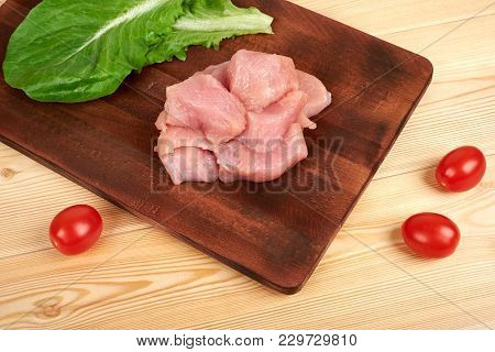 Turkey Raw Breast Pieces On A Cutting Board Wooden Background.