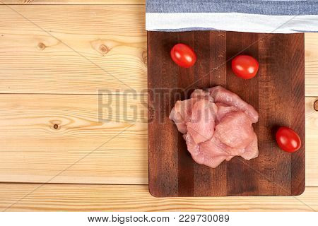 Turkey Raw Breast Pieces On A Cutting Board Wooden Background, Copyspace For Your Text.