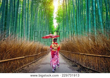 Bamboo Forest. Asian Woman Wearing Japanese Traditional Kimono At Bamboo Forest In Kyoto, Japan.