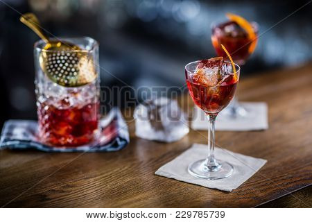 Manhattan Cocktail Drink Decorated On Bar Counter In Pub Or Restaurant.