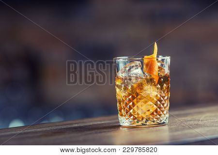 Old Fashioned Classic Cocktail Drink In Crystal Glass On Bar Counter.