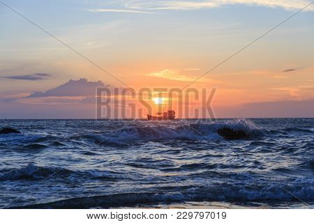Boat Floating In The Sea For Fishing In The Sunset