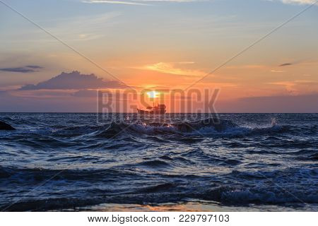 Boat Floating In The Sea For Fishing In The Sunset