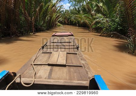 Boating On A Dirty River With Conical Hats In The Mekong Delta, Vietnam