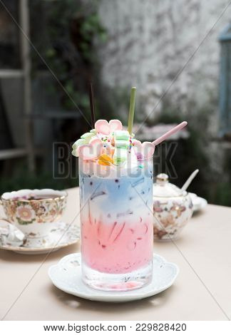 Pastel Milk (drink.beverage) Topping With Marshmallow And Pocky In Long Glass.