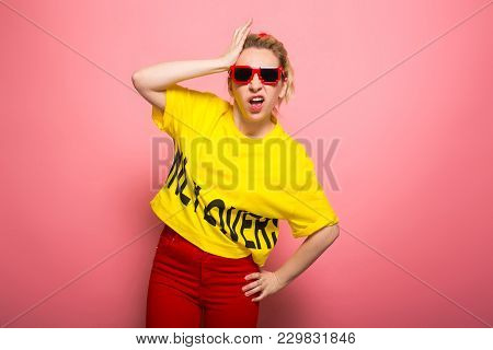 Attractive Woman In Yellow T-shirt, Red Jeans And Sunglasses Forget Something Holding Hand On Her He