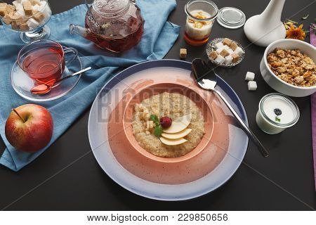 Delicious Restaurant Breakfast Background. Oatmeals Porrige With Fresh Berries And Pear On Pink Plat