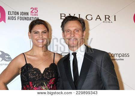 LOS ANGELES - MAR 4:  Anna Musky-Goldwyn, Tony Goldwyn at the 2018 Elton John AIDS Foundation Oscar Viewing Party at the West Hollywood Park on March 4, 2018 in West Hollywood, CA