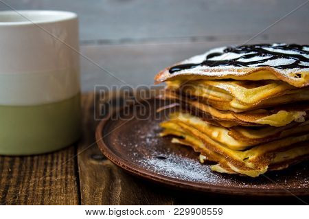A Cup Of Tea And A Pile Of Wafers