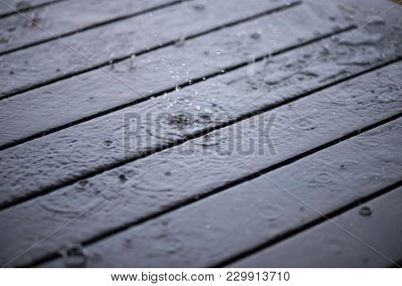 Rain Drops On Wooden Deck Close Up