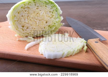 Fresh Ripe Chinese Cabbage And Knife On The Cutting Board. Ingredients For Salad. Ready For Cooking.