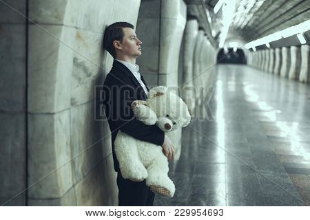 Man Is Sad With A Teddy Bear Toy In His Hands. The Concept Of His Beloved Woman Did Not Come To The 