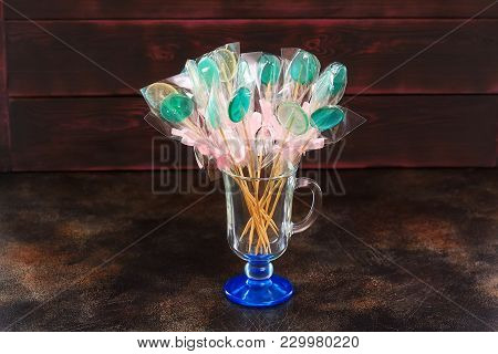 Green Candy Lollipops In Cup On Dark Background, Closeup
