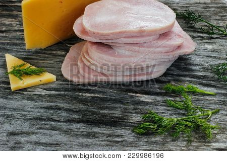Sliced Meat Pieces, Bacon, Cold Boiled Pork, Balyk With Cheese On A Wooden Surface. Snack. Meat Dish