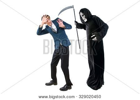 Man In A Halloween Grim Reaper Ghost Costume Chasing, Mocking And Making Fun Of Scared Businessman R