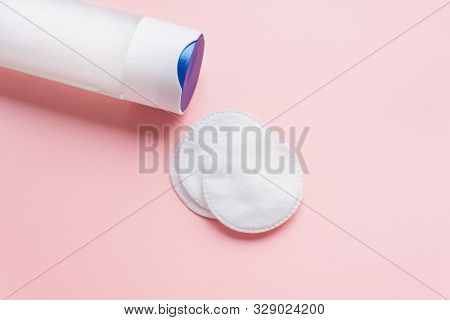 Micellar Water With Cotton Pads On A Pastel Pink Background. The Concept Of Cleansing And Moisturizi
