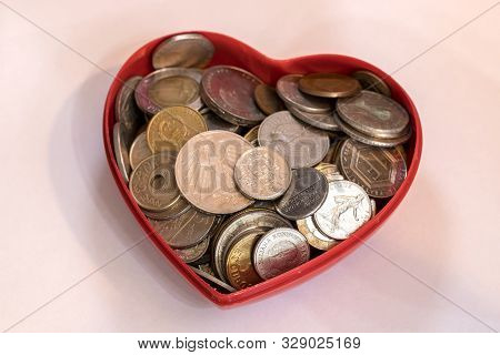 Old Coins Background Macro Closeup In A Heart Shaped Container