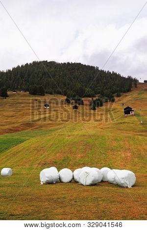 Accurately packed haystacks on charming mountain meadows. Switzerland, the Alpes