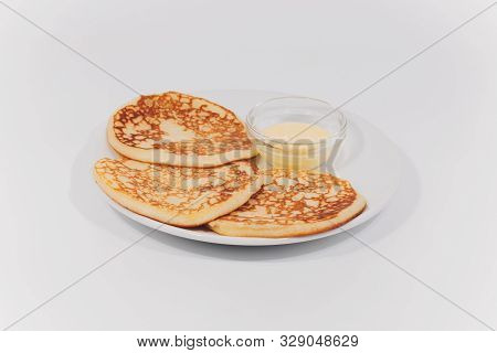 Plate With Fritters On White Wooden Table. Studio Photo.