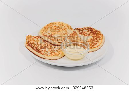 Plate With Fritters On White Wooden Table. Studio Photo.