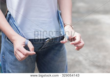 Woman In Oversize Jeans Showing How Much Weight Lost. Diet Fat Weight Loss Healthy Lifestyles Concep