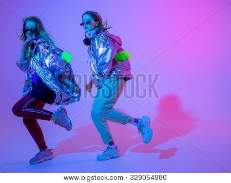 Young Stylish Girls Dancing In The Studio On A Colored Neon Background. Music Dj Poster Design.