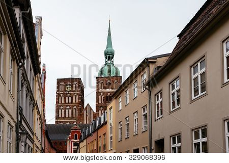 Traditional Colorful Houses And Church Tower In The Old Town Of Stralsund
