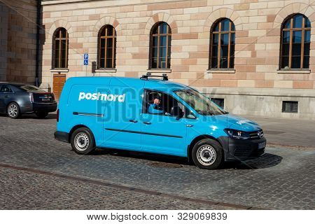 Stockholm, Sweden - April 18, 2019: Blue Volkswagen Caddy Van Car Of The Postnord Post Office Compan