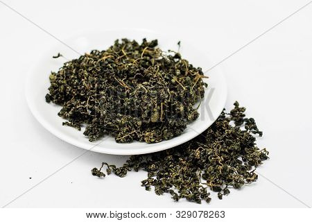 Dry Gynostemma Pentaphyllum Leaf In A White Plate On White Blackground