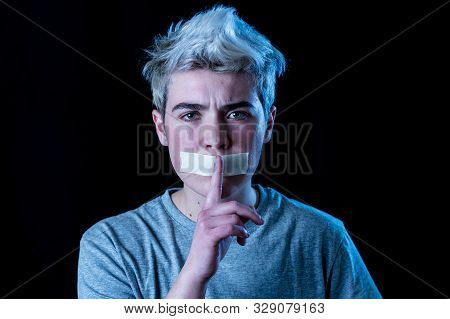 Handsome Young Transgender Teenager Man With Mouth Sealed Making Silence Gesture