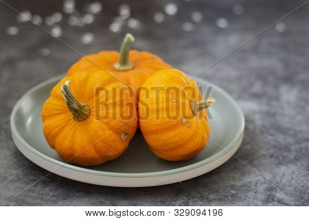 Autumn Background With Pumpkins On Dark Board. Halloween, Thanksgiving Orange Little Pumpkins.
