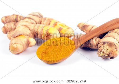 Turmeric Powder (curcuma) In Wood Spoon On White Background. Herbal