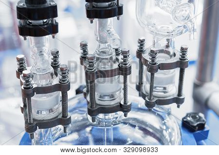 The Upper Part Of The Chemical Reactor. The Glass Reactor Lid Is Equipped With Piping. Glass Pipes A
