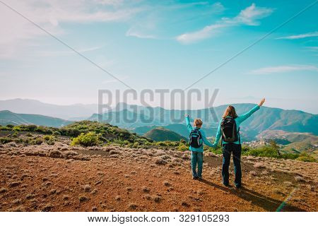 Family Travel- Mother And Son Hiking In Mountains