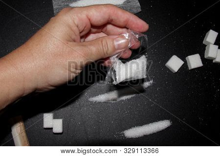 Hand Of A Man With A Pack Of Sugar Like It Was Drug