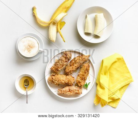Fried Bananas On Plate Over White Stone Background. Tasty Dessert From Pan Fried Bananas In Asian St