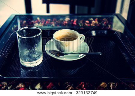 Drunk Coffee With Water In Glass On Dark Table Vintage Picture