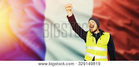 Protests Yellow Vests. The Man Raised His Hand Into A Fist And Shouted. The Concept Of Revolution An