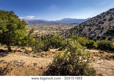 Top View Of The Lassithi Plateau On A Sunny Day With Cloudy Sky.