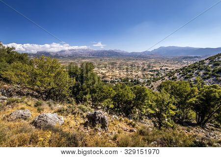 Top View Of The Lassithi Plateau On A Sunny Day With Cloudy Sky.