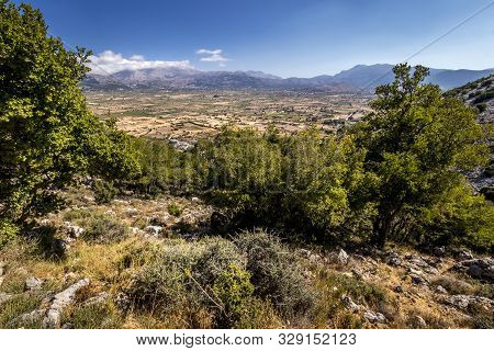 Top View Of The Lassithi Plateau On A Sunny Day With Cloudy Sky.