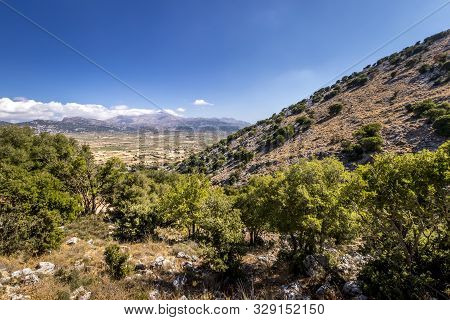 Top View Of The Lassithi Plateau On A Sunny Day With Cloudy Sky.