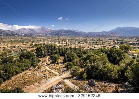 Top View Of The Lassithi Plateau On A Sunny Day With Cloudy Sky.